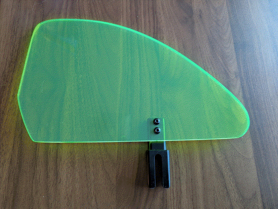 dithered photo of a bright green side guard taken from above, attached to a mounting hardware laying on a wood table